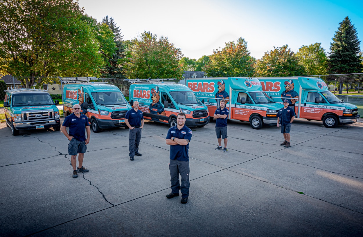 Bears Home Solutions employees stand in front of work vans.
