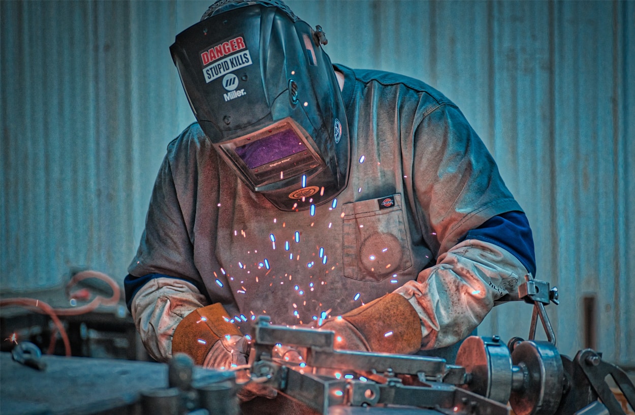Action shot of man welding.